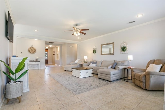 tiled living room with ceiling fan and crown molding