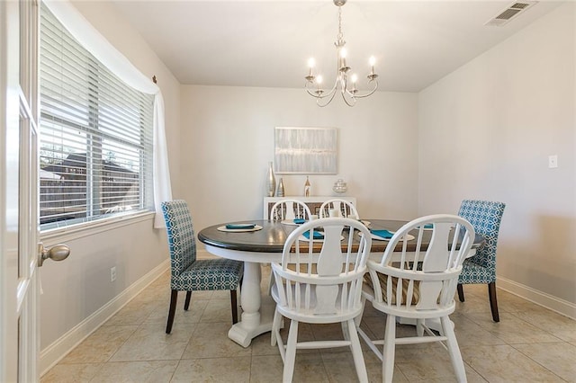 tiled dining space featuring a chandelier