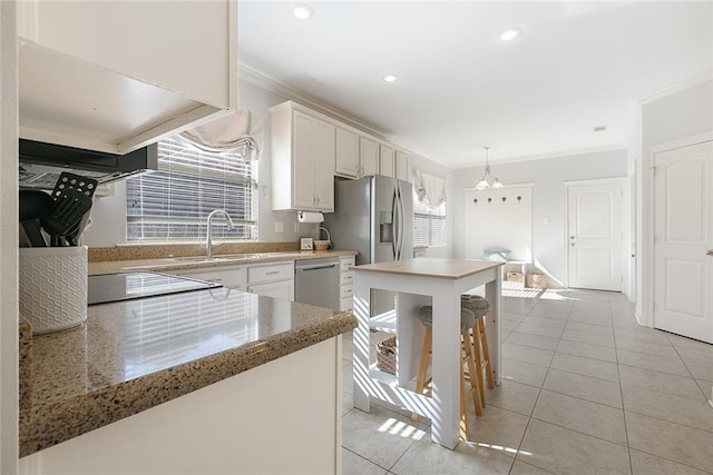 kitchen featuring white cabinets, ornamental molding, sink, and light tile patterned floors