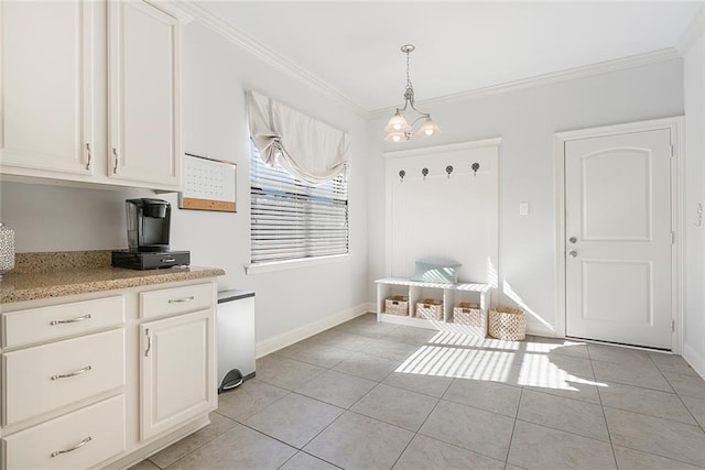 mudroom with light tile patterned flooring, crown molding, and a chandelier