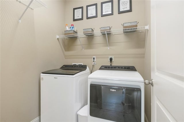 clothes washing area featuring washer and clothes dryer