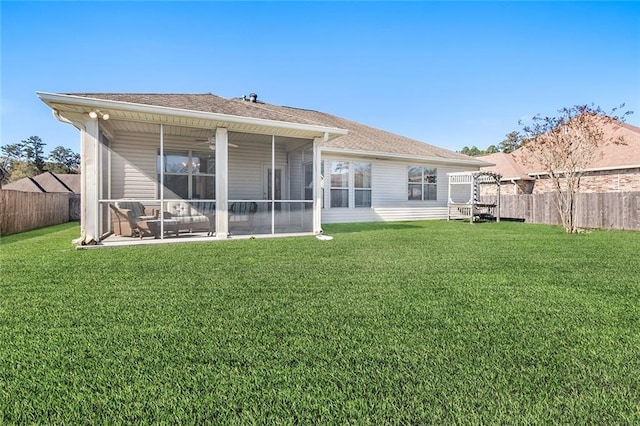 back of house featuring a lawn