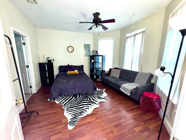 bedroom with ceiling fan and dark hardwood / wood-style flooring