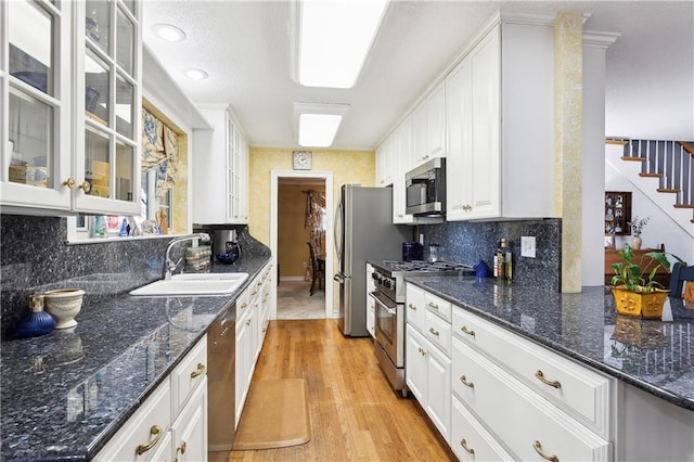 kitchen featuring white cabinets, backsplash, sink, and stainless steel appliances