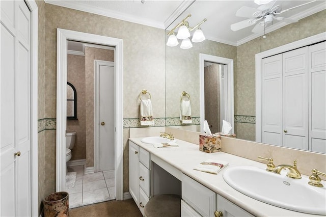 bathroom featuring ceiling fan, tile patterned floors, crown molding, toilet, and vanity