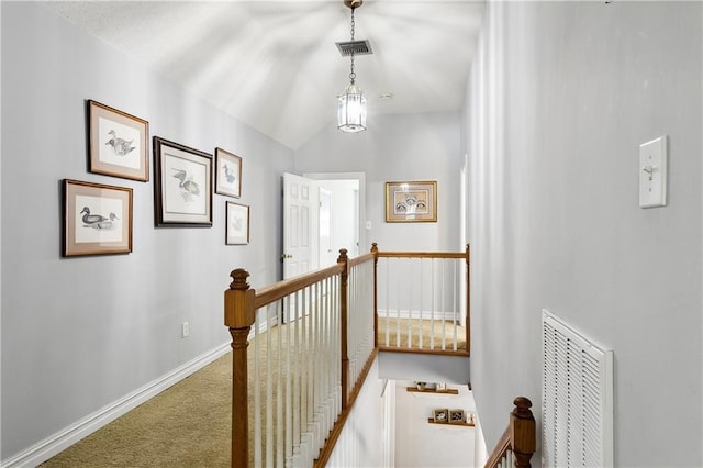 hallway featuring carpet and lofted ceiling