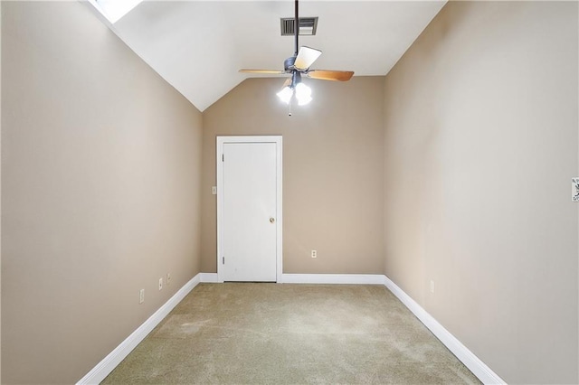 unfurnished room with ceiling fan, carpet floors, and vaulted ceiling