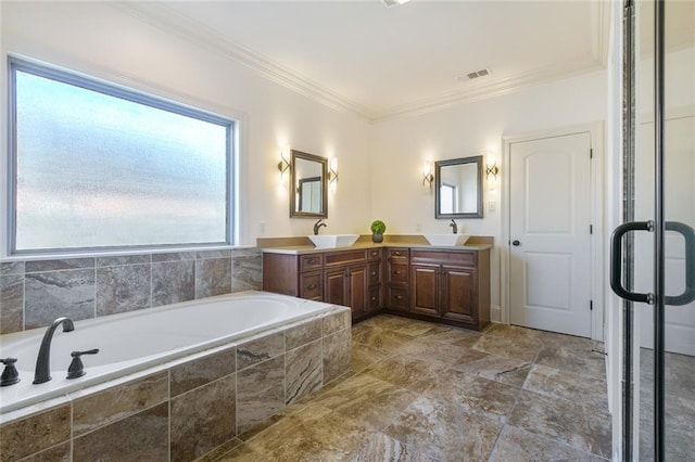 bathroom featuring vanity, ornamental molding, and tiled tub