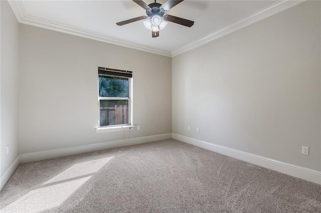 carpeted spare room featuring crown molding and ceiling fan