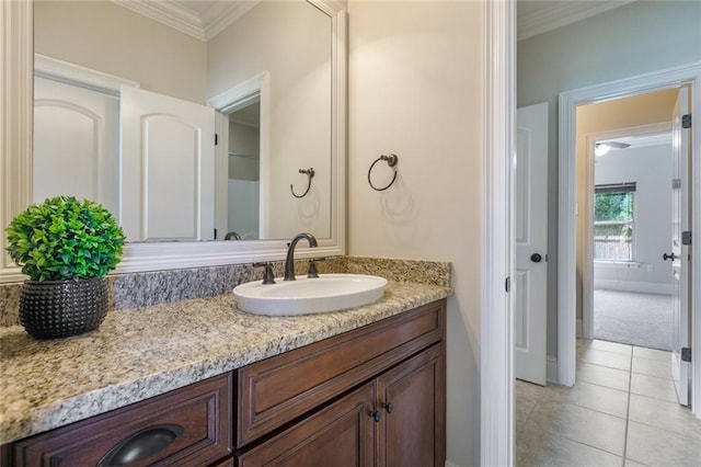 bathroom featuring tile patterned flooring, vanity, and ornamental molding