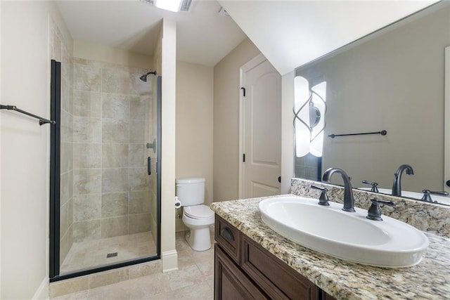 bathroom featuring tile patterned floors, vanity, an enclosed shower, and toilet