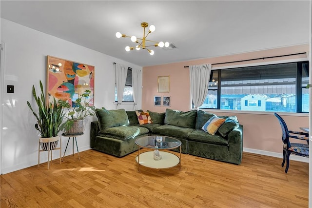 living room featuring light hardwood / wood-style flooring and a notable chandelier