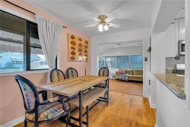 dining space with ceiling fan, light hardwood / wood-style floors, and a wealth of natural light