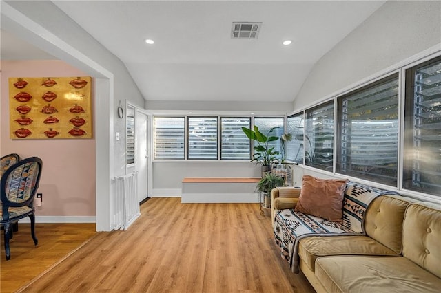 interior space with light hardwood / wood-style floors and vaulted ceiling