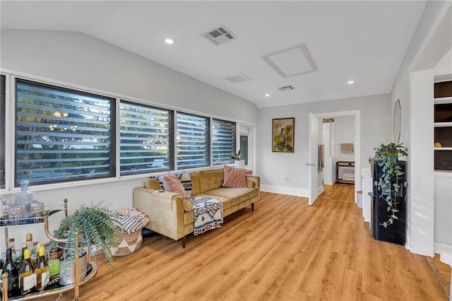 living room featuring lofted ceiling and light wood-type flooring