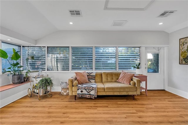 living room featuring light hardwood / wood-style flooring and lofted ceiling