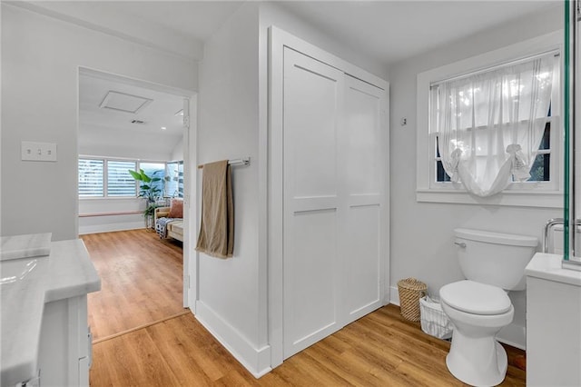 bathroom featuring hardwood / wood-style floors, vanity, and toilet