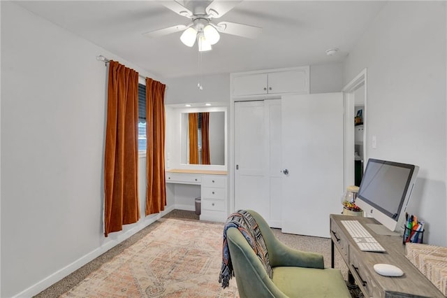 home office featuring ceiling fan and light colored carpet