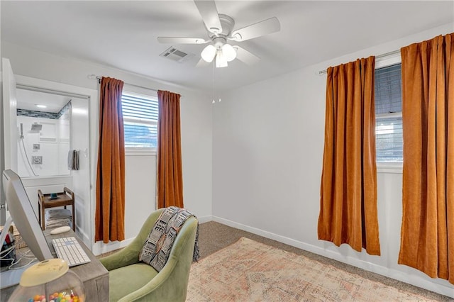 living area with light colored carpet and ceiling fan