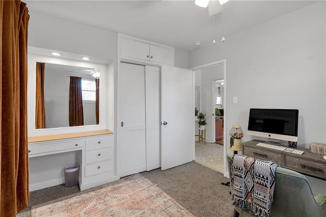 carpeted home office with ceiling fan