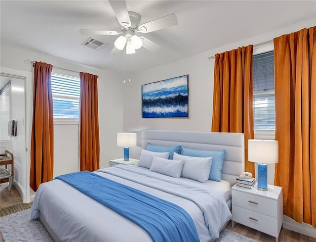 bedroom with light hardwood / wood-style floors and ceiling fan