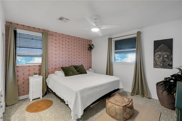 bedroom with multiple windows and ceiling fan