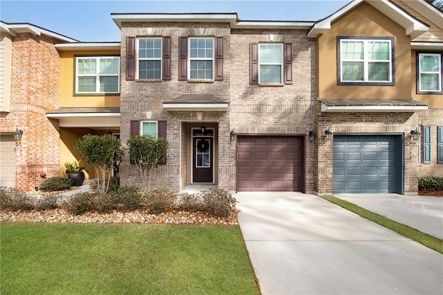 view of property with a front lawn and a garage