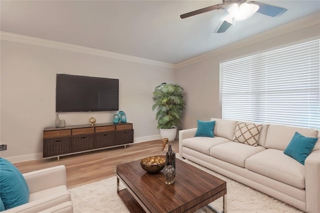 living room with light hardwood / wood-style flooring and ornamental molding