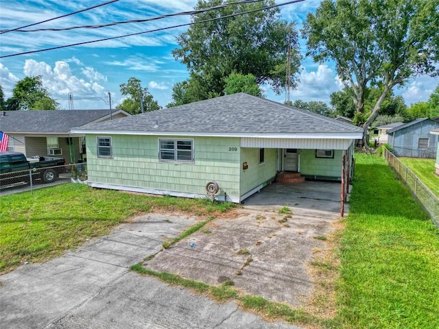 back of house with a yard and a carport