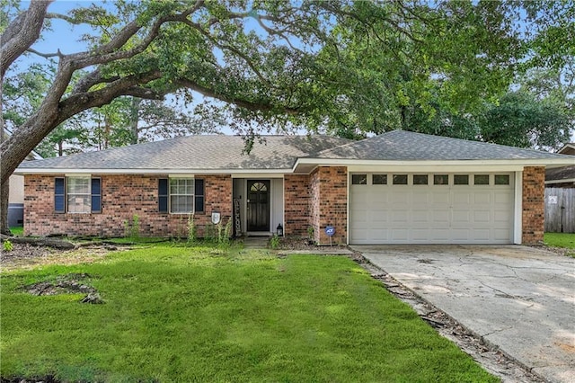 ranch-style home with a front yard and a garage