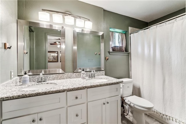 bathroom with ceiling fan, vanity, and toilet