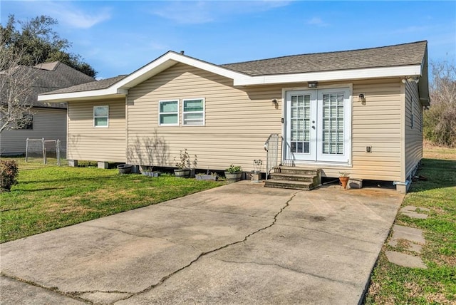 rear view of house featuring a yard