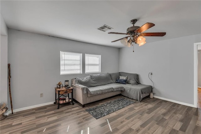 living room featuring ceiling fan and wood-type flooring