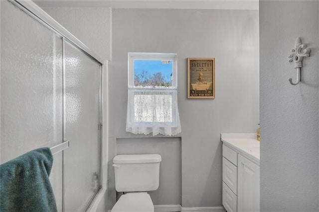 full bathroom featuring shower / bath combination with glass door, vanity, and toilet