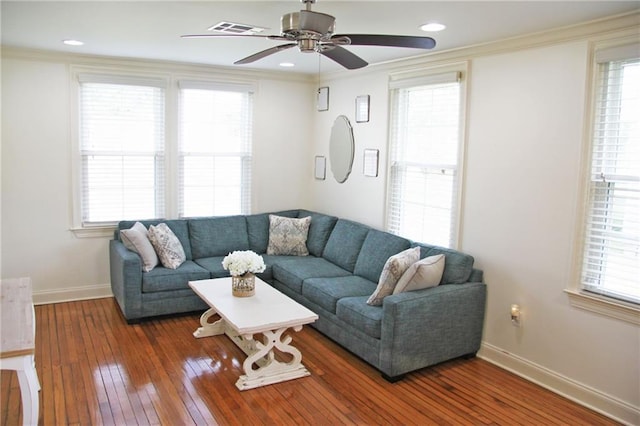 living room with hardwood / wood-style floors, plenty of natural light, ceiling fan, and ornamental molding