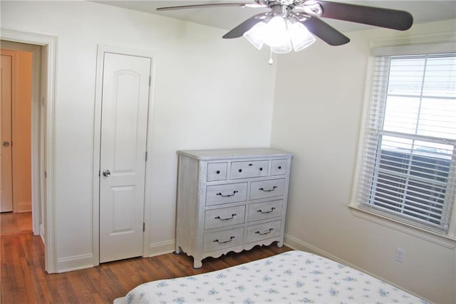 bedroom featuring dark hardwood / wood-style flooring and ceiling fan