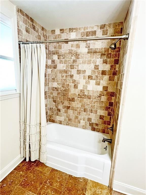 bathroom with shower / bath combination with curtain