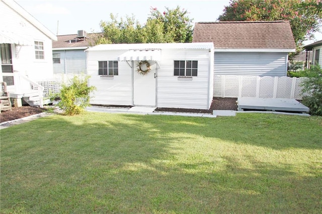 rear view of house featuring a yard