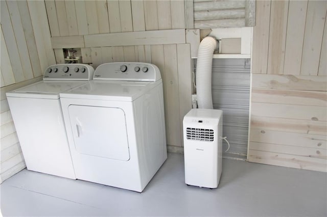 washroom featuring independent washer and dryer and wooden walls