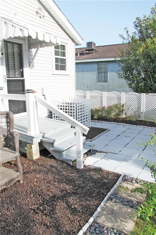 exterior space featuring cooling unit, a patio area, and a wooden deck