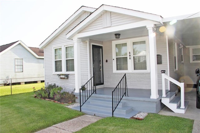 doorway to property with a lawn