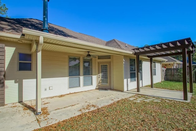 entrance to property with ceiling fan and a patio area