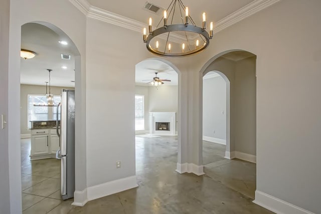 hall featuring crown molding and an inviting chandelier