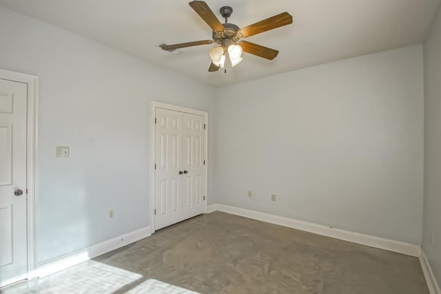 empty room with ceiling fan and concrete flooring