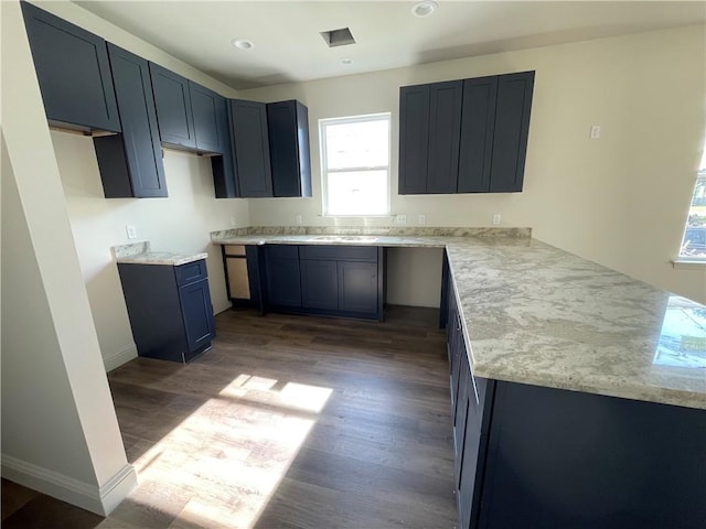 kitchen featuring kitchen peninsula, light hardwood / wood-style flooring, and sink