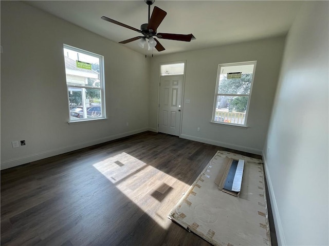 spare room with dark hardwood / wood-style floors and ceiling fan