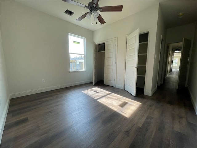 unfurnished bedroom with ceiling fan and dark hardwood / wood-style floors