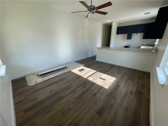 unfurnished living room featuring dark hardwood / wood-style floors and ceiling fan