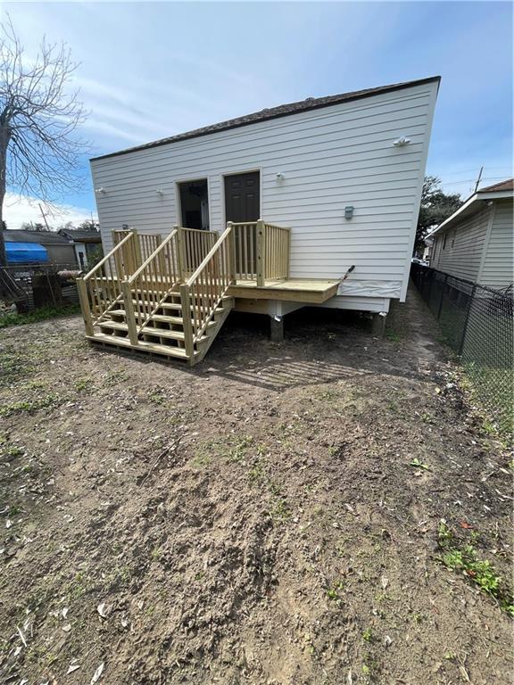 back of property featuring a wooden deck