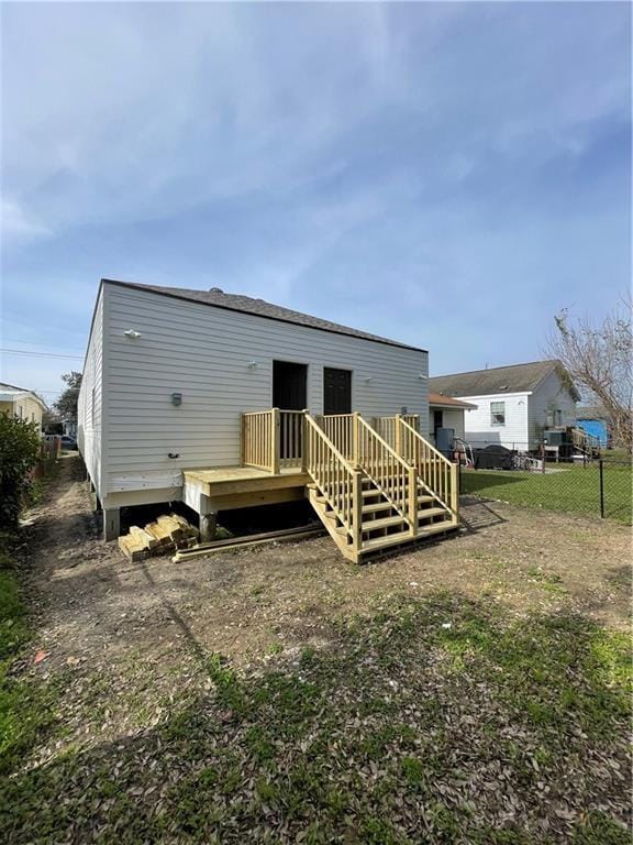 rear view of house featuring a wooden deck